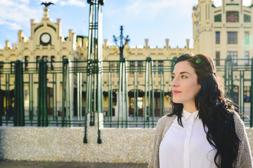 Fototapeta premium Portrait of mature woman waiting outside, side view.