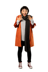 A full-length shot of a Short hair woman with coat with surprise facial expression over isolated white background