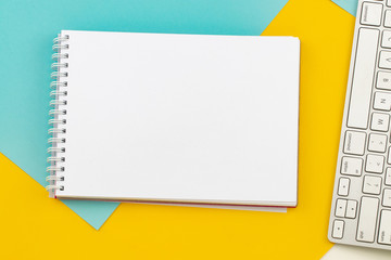 Modern office desk table with keyboard  and notebook  top view copy space