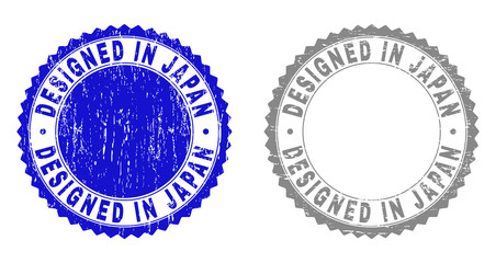 Grunge DESIGNED IN JAPAN stamp seals isolated on a white background. Rosette seals with distress texture in blue and grey colors.
