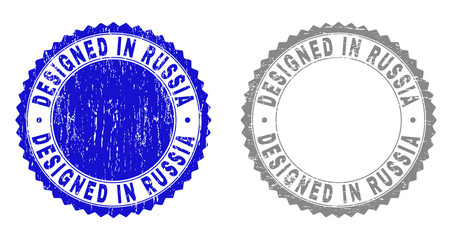 Grunge DESIGNED IN RUSSIA stamp seals isolated on a white background. Rosette seals with grunge texture in blue and grey colors.