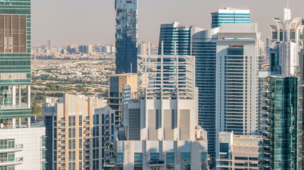 Dubai marina and JLT skyscrapers aerial skyline during sunset timelapse.