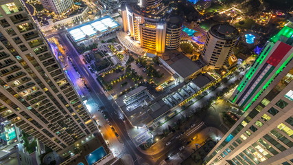 Aerial view of modern skyscrapers and beach at Jumeirah Beach Residence JBR night timelapse in Dubai, UAE