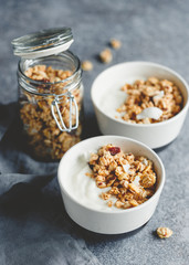 Breakfast bowls with organic granola, nuts, coconut chips and greek yoghurt.