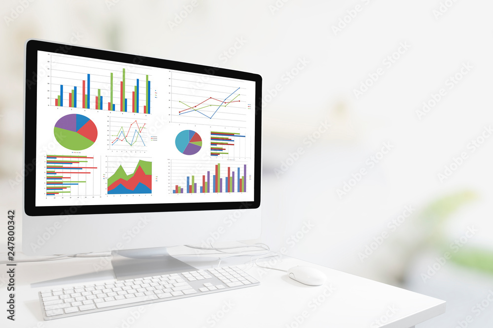 Poster Modern computer with keyboard and mouse on white table showing charts and graph on screen against white modern clean indoor background , Analysis Business, Statistics Concept