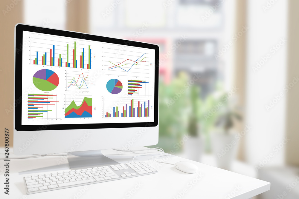 Poster Modern computer with keyboard and mouse on white table showing charts and graph on screen against  modern  indoor  green plants and window background , Analysis Business, Statistics Concept