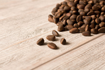 Pine nuts on a wooden table. Selective focus