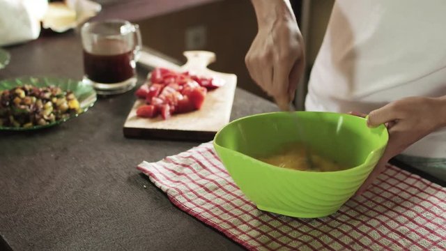 Cooking scramble egg in simple kitchen