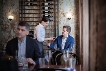 Waitress taking payment in a restaurant