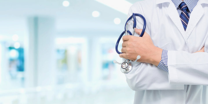 Doctor with a stethoscope in the hands behind on the hospital background / Medical concepts and health care