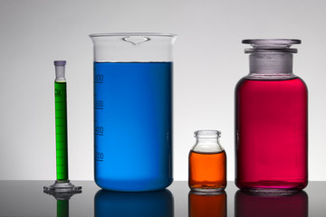 Liquid in laboratory bottles. Scientific biochemical laboratory. Colorful liquid.