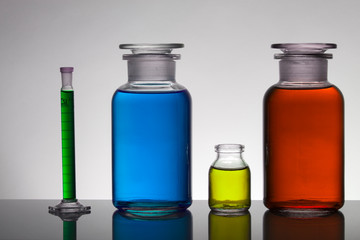 Liquid in laboratory bottles. Scientific biochemical laboratory. Colorful liquid.