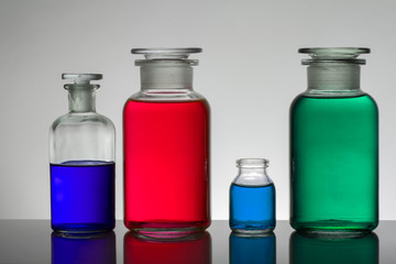 Liquid in laboratory bottles. Scientific biochemical laboratory. Colorful liquid.