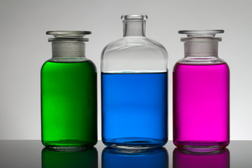 Liquid in laboratory bottles. Scientific biochemical laboratory. Colorful liquid.