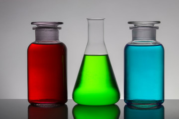 Liquid in laboratory bottles. Scientific biochemical laboratory. Colorful liquid.