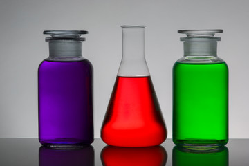 Liquid in laboratory bottles. Scientific biochemical laboratory. Colorful liquid.
