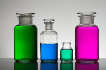 Liquid in laboratory bottles. Scientific biochemical laboratory. Colorful liquid.