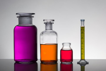Liquid in laboratory bottles. Scientific biochemical laboratory. Colorful liquid.