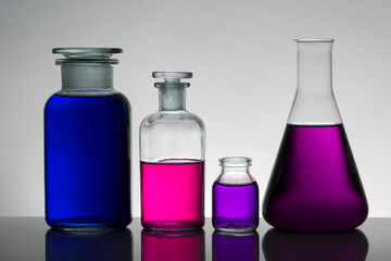 Liquid in laboratory bottles. Scientific biochemical laboratory. Colorful liquid.