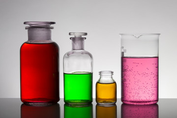 Liquid in laboratory bottles. Scientific biochemical laboratory. Colorful liquid.