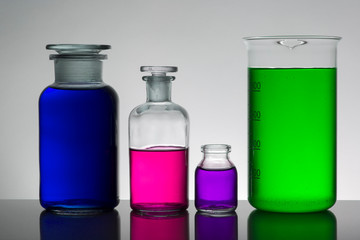 Liquid in laboratory bottles. Scientific biochemical laboratory. Colorful liquid.