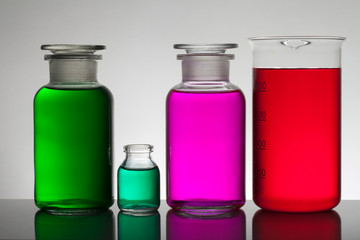 Liquid in laboratory bottles. Scientific biochemical laboratory. Colorful liquid.