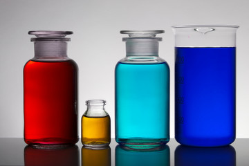 Liquid in laboratory bottles. Scientific biochemical laboratory. Colorful liquid.