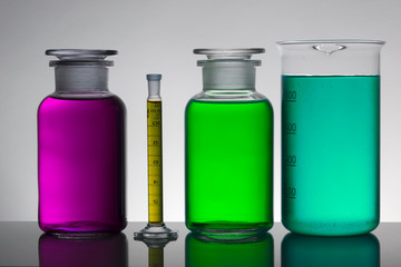 Liquid in laboratory bottles. Scientific biochemical laboratory. Colorful liquid.