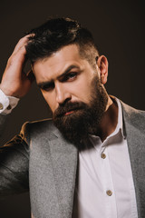 handsome stylish beard businessman isolated on brown