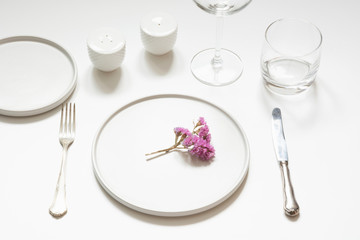 Elegance table setting with flowers on white table.