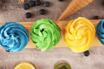 Vanilla frozen yogurt or colorful soft ice cream in waffle cone.