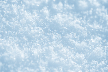 Fresh snow background texture. Winter background with snowflakes and snow mounds. Snow lumps.
