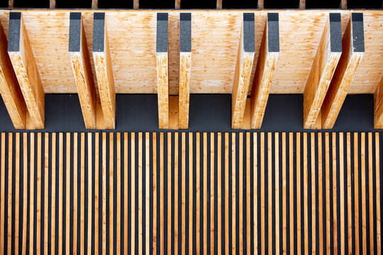 Fragment of the roof and walls of the house. An unusual combination of lines.