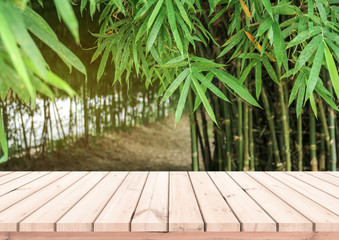 Wood plank with abstract natural blurred bamboo forest and bokeh background for product display