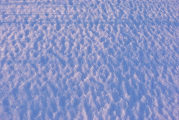 Wavy textured snow (wind effect), natural background, close up detail top view