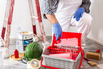 Professional house painter at work with the roller © francescomou