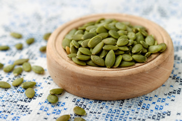 Peeled pumpkin seeds in wood bowl