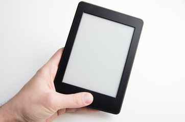 Hand holding blank ebook with blank screen