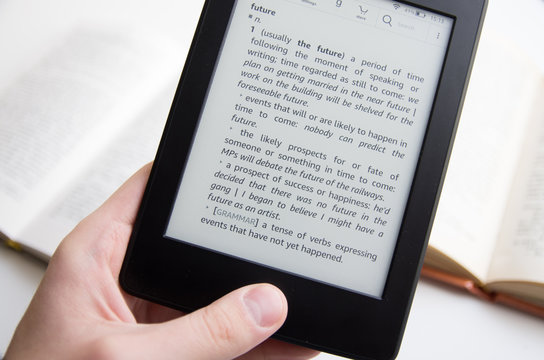 Hand holding ebook with text about future