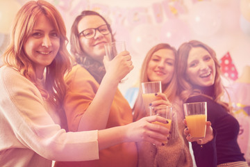 Pregnant woman celebrating baby shower party with friends.