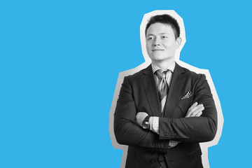 Successful adult businessman in suit over gray background.