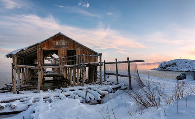 Old abandoned wooden dock at sunset.  Teriberka, Murmansk district. Kola Peninsula. Russian polar region. Barents Sea