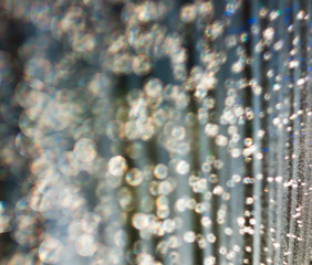 The unfocused background of the silver glitter of water droplets on the black for text, banner,...