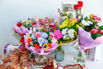 bouquet of flowers in vase on wooden table
