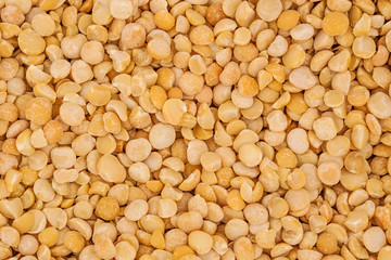 Dry yellow split peas background texture
