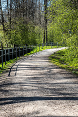 empty country gravel road with mud puddles and bumps