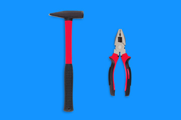 Single metal hammer with red and black rubber handle isolated on white background