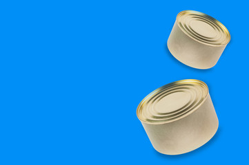 Two cans of canned food on blue background with copy space for your text