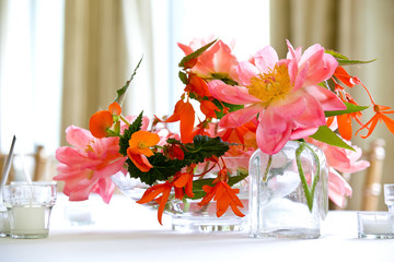 Pink and red bouquet of flowers on a table during a wedding event 