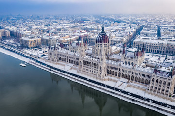 Budapest, Hungary - Aerial view of the beautiful snowy Parliament of Hungary and skyline of Pest at winter time